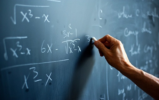 Mathematician writing on chalk board