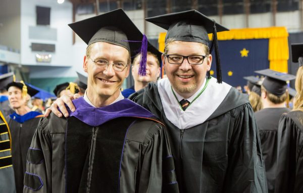 <i>UAF photo by JR Ancheta</i><br> UAF faculty XXXXXX and Rob Prince pause during Commencement 2014.