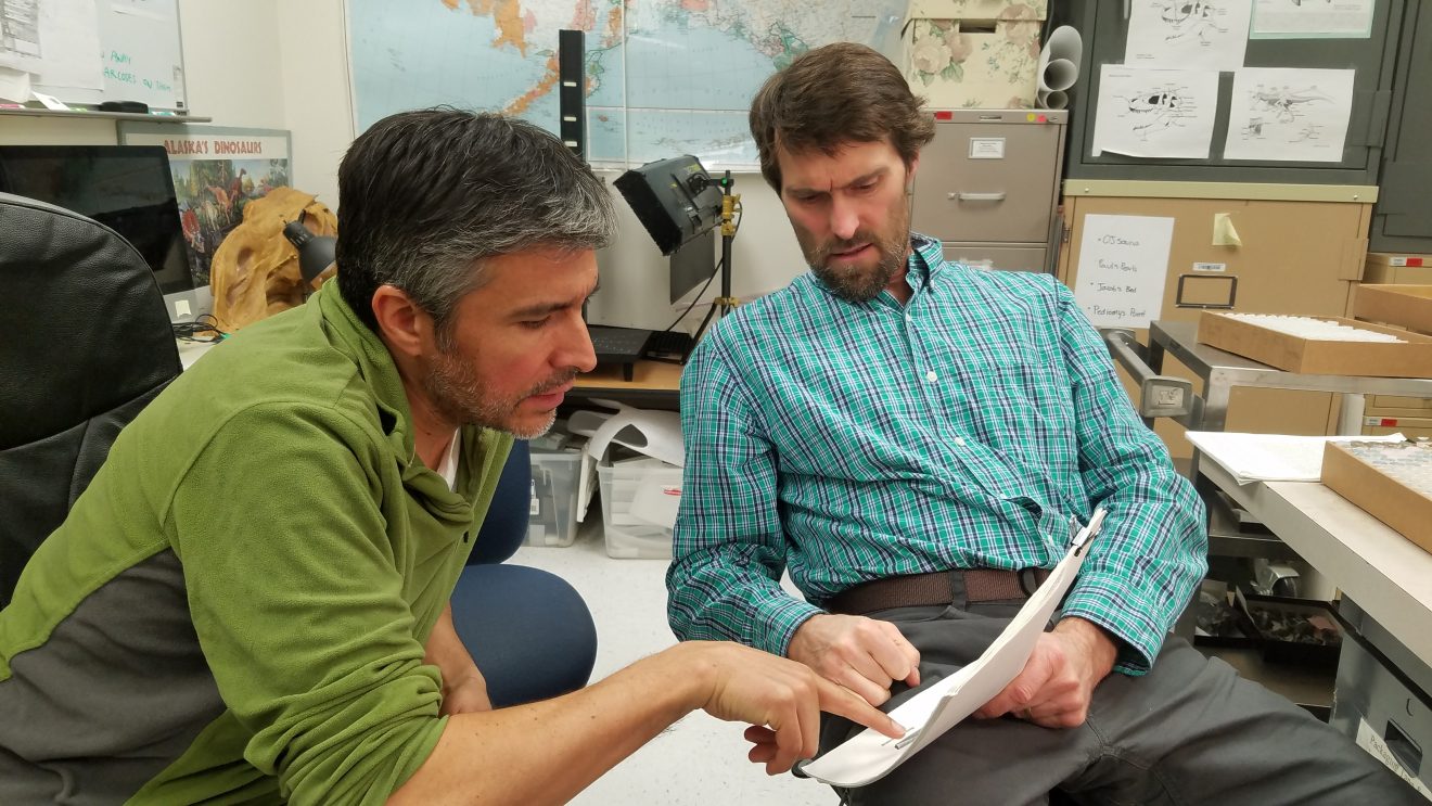 Photo by Theresa BakkerAndrés López, left, curator of fishes, and Pat Druckenmiller, curator of earth sciences, talk about the fish fossil record in Alaska.