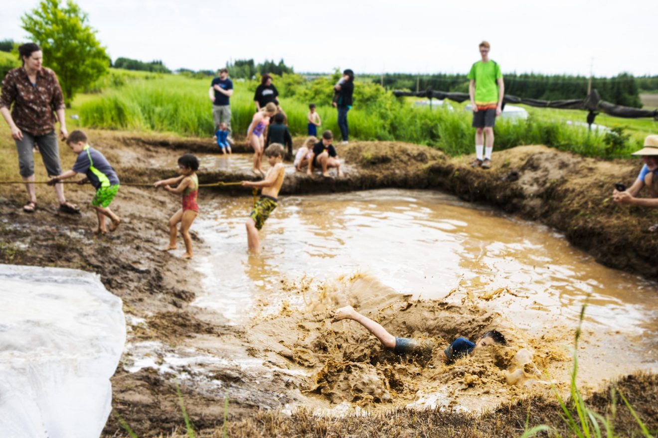 Children enjoy a mud pit during this year's Birthday Bash and Mud Day at the Georgeson Botanical Garden Sunday, June 24.