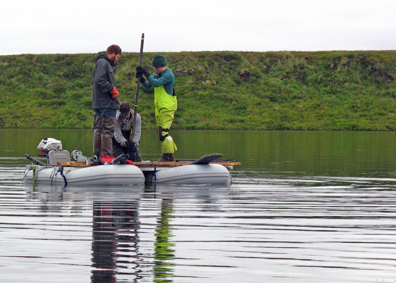 Photo courtesy of Nancy BigelowResearchers working with ecologist Nancy Bigelow pull a sediment core from a deep lake in western Alaska near Shishmaref, looking for pollen preserved from the days of the Bering land bridge.