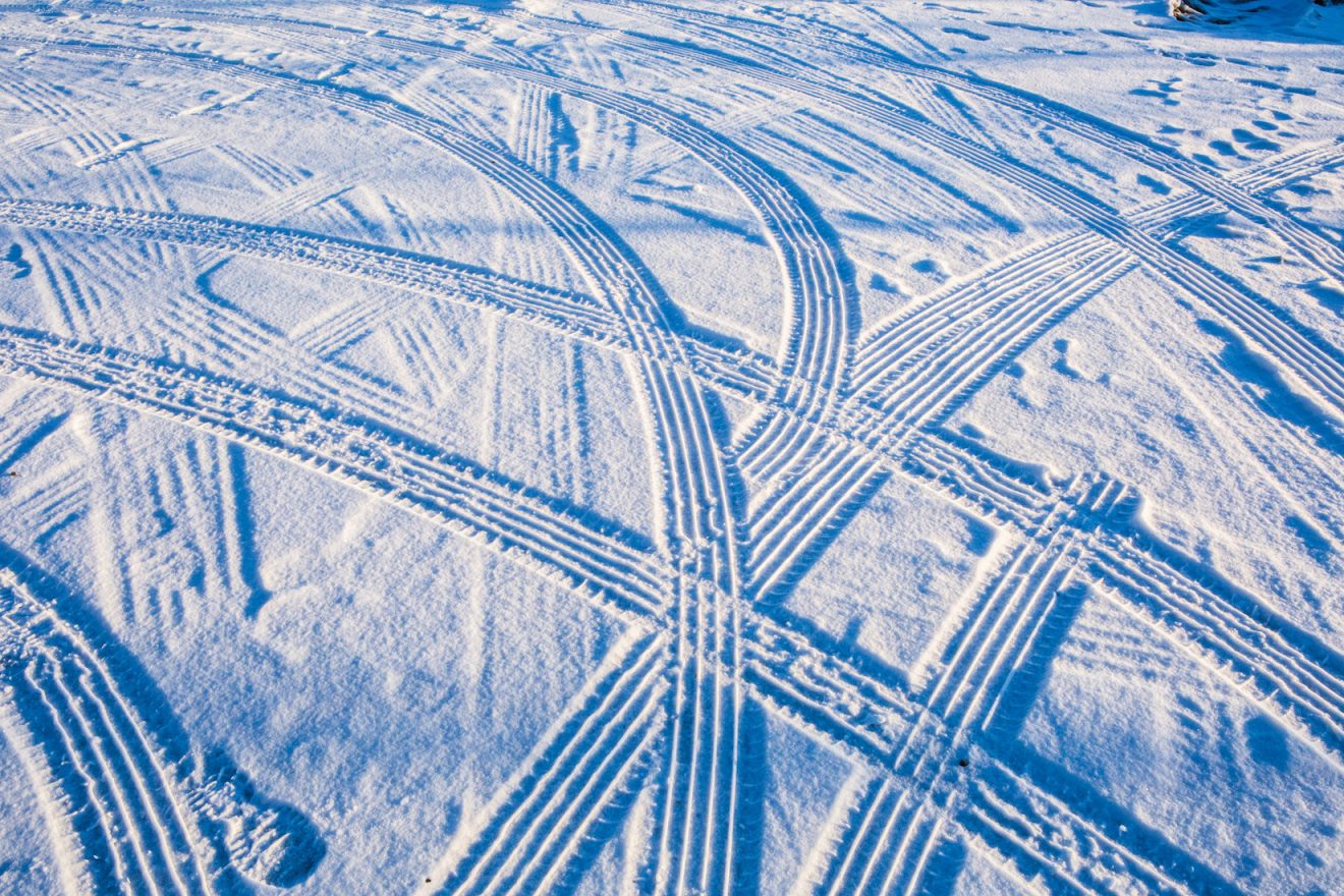 Patterns from tire tracks on snow blanket the ground on the Fairbanks campus.