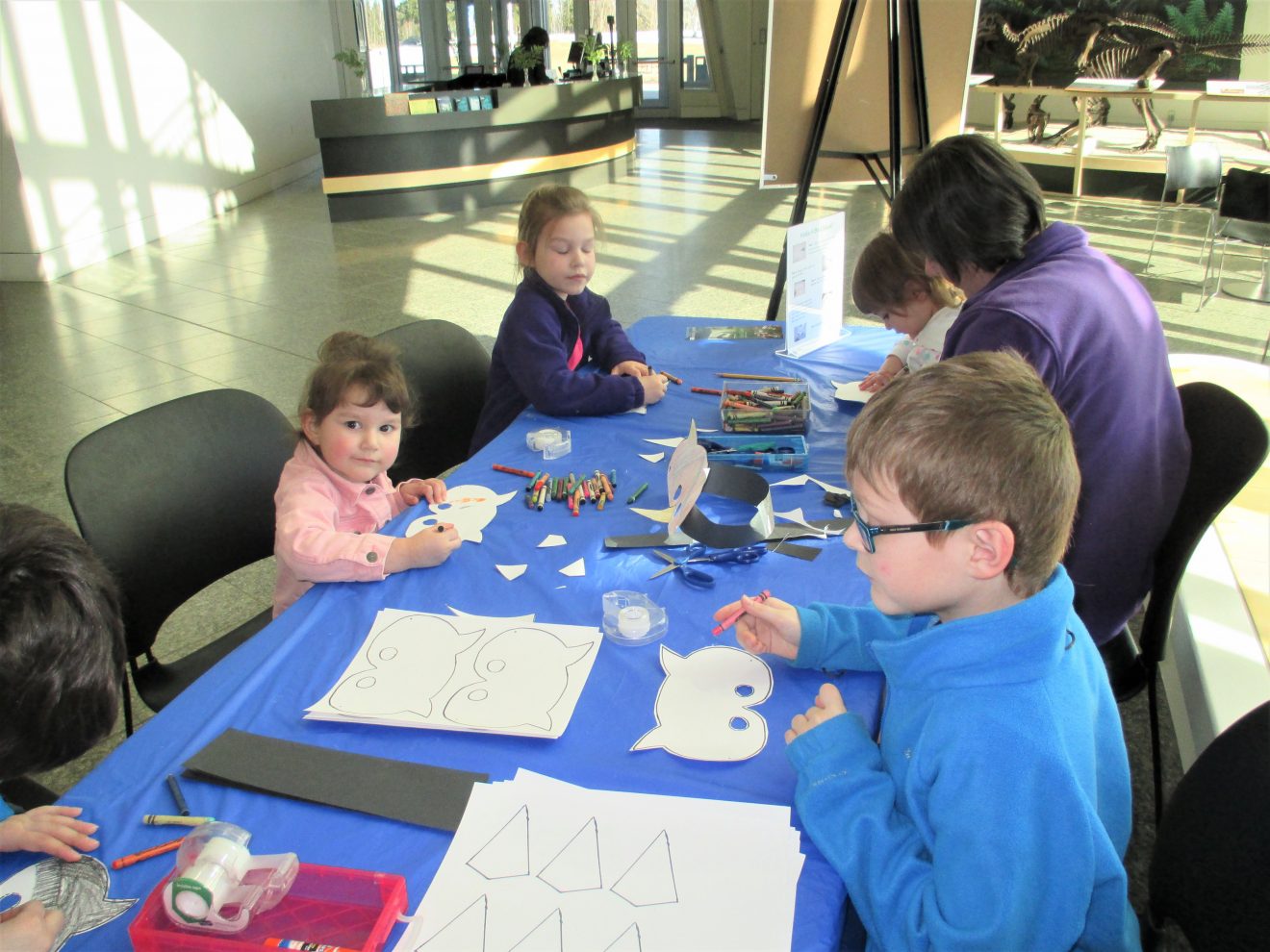 Visitors make bird crafts during a program at the museum.