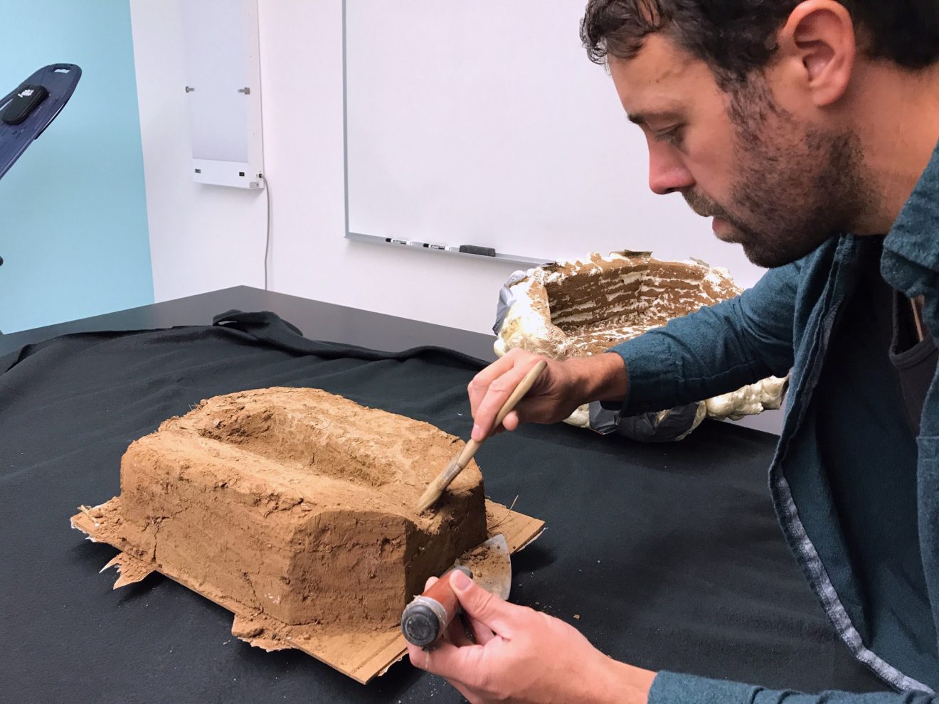 Photo courtesy of Gerad SmithUniversity of Alaska Fairbanks doctoral candidate Gerad Smith does a final cleaning of the footprint in the University of Alaska Anchorage ALCES lab before a 3D image is made of the print.