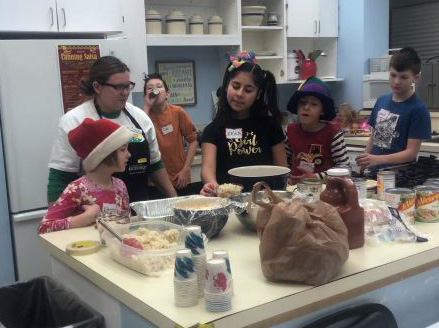 Candi Dierenfield photo Nutrition educator Britanny Balthaser helps youth make a nutritious lunch at a Healthy Habits Champs event.