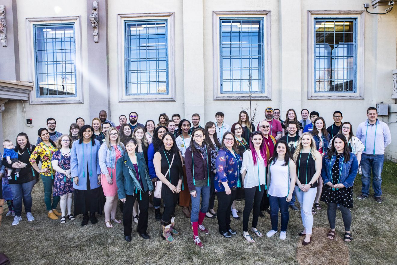 First-generation graduates gather for a group photo in front of Signers' Hall after a cording ceremony Saturday, April 27, 2019, on the Fairbanks campus. These graduates are the first people in their families to complete a higher education degree program.