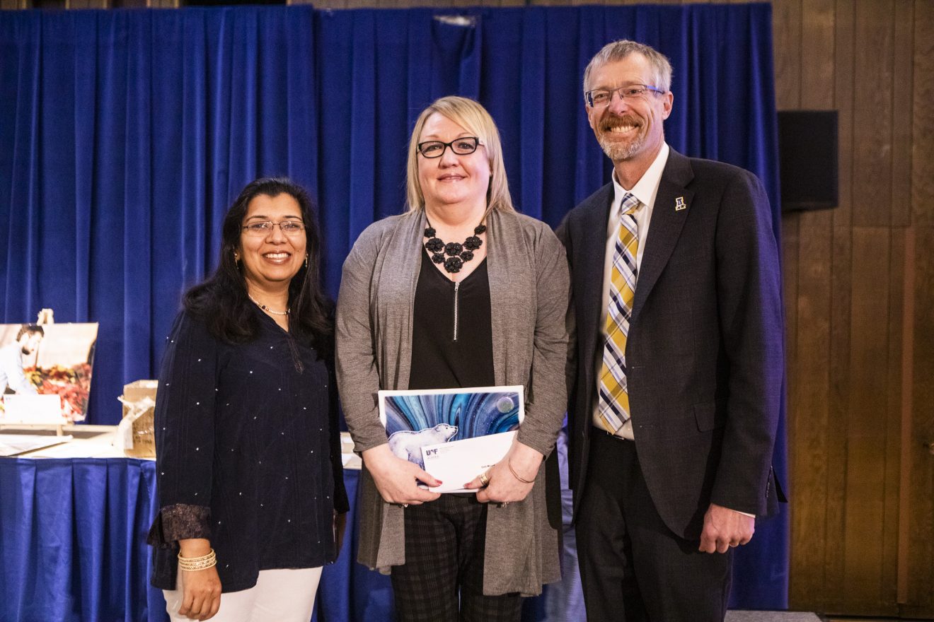 35-year employee Deb Moore received her longevity award from Anupma Prakash and Dan White.