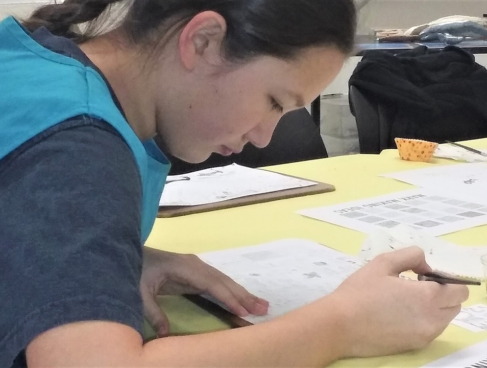A participant makes a drawing at an ARTSci Teen Workshop.