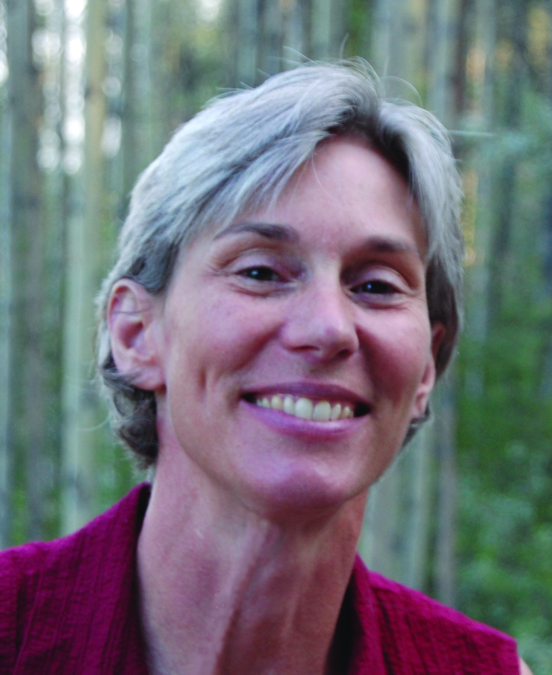 Head shot of Diane Wagner. The trees behind her may be aspen.