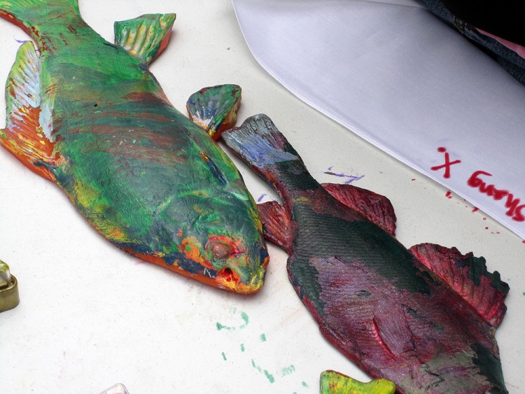 Two fish forms covered in paint.