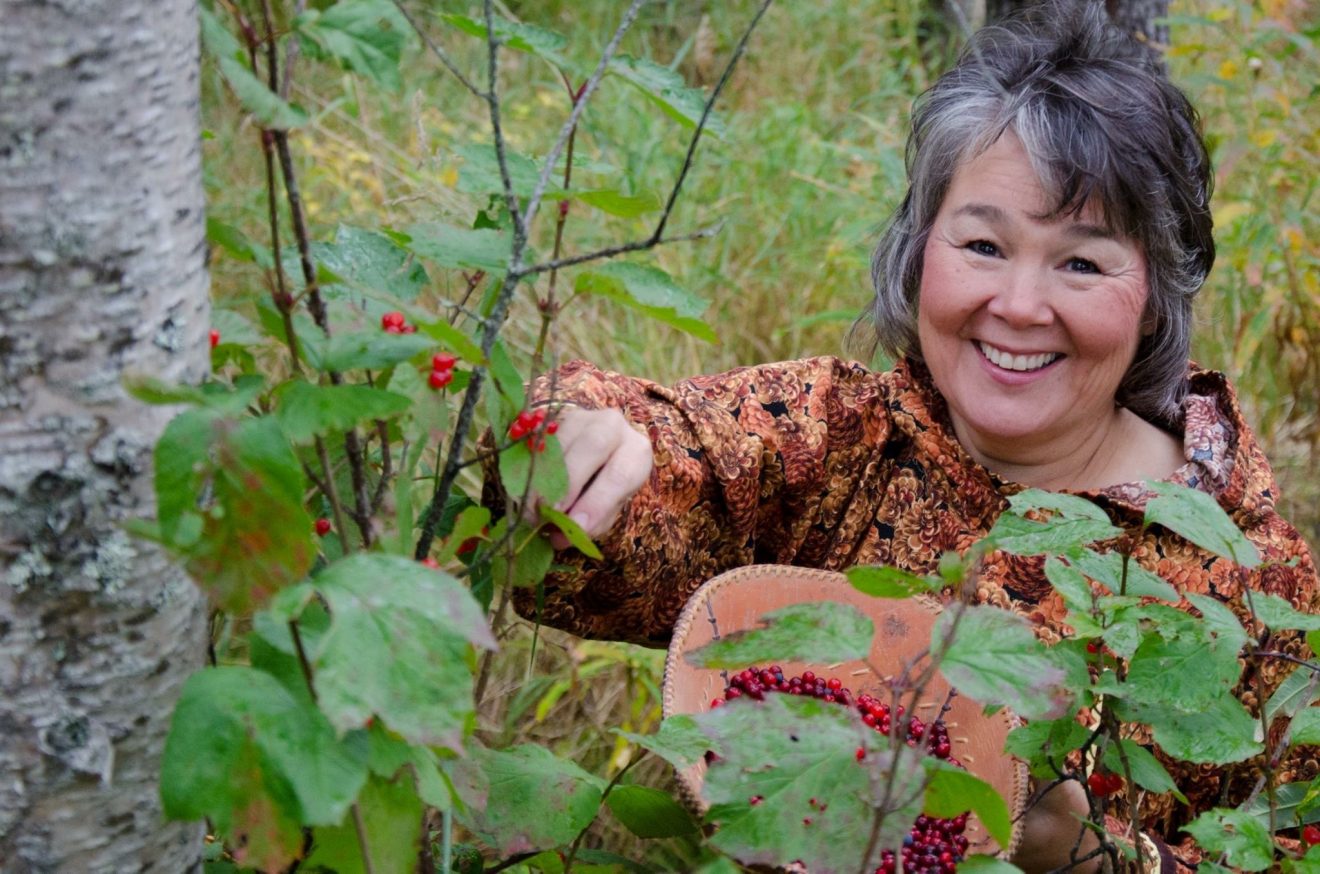 Photo of Kim Williams picking cranberries.