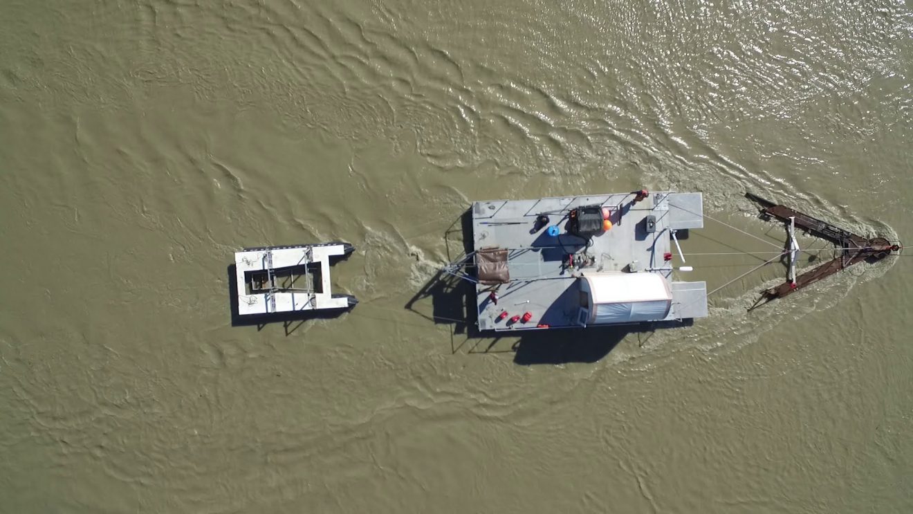 Photo by Paul Duvoy. An aerial view shows a hydrokinetic turbine test site at the Alaska Center for Energy and Power's Tanana River test site near Nenana in July 2020.