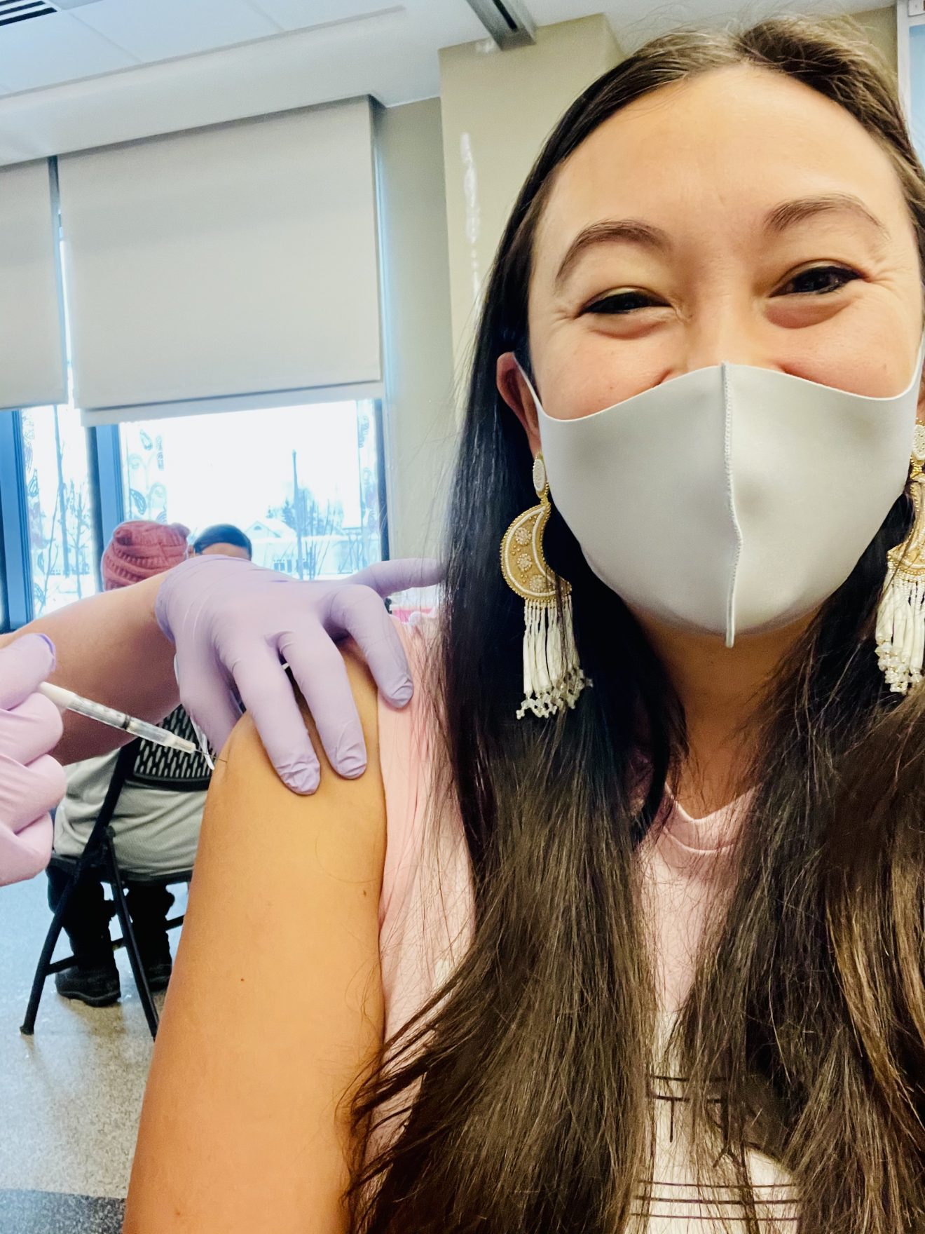 Woman with mask getting vaccinated