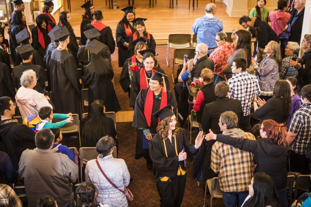 Graduates receive a warm reception from friends, family members, staff and faculty during the recessional of the 2018 Northwest Campus graduation ceremony Thursday, May 10, at the Old St. Joe's Hall in Nome.