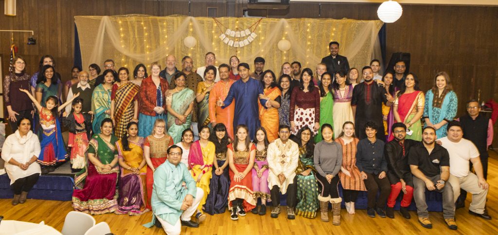 Large group of people mostly dressed in traditional Indian clothing.