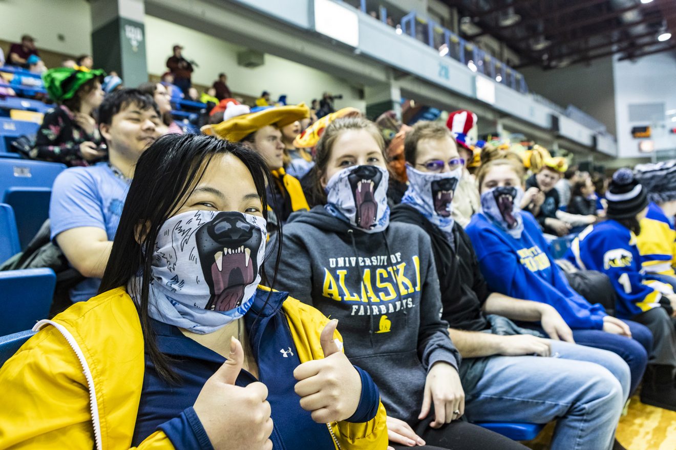 Fans wear bear masks across the lower half of their face.