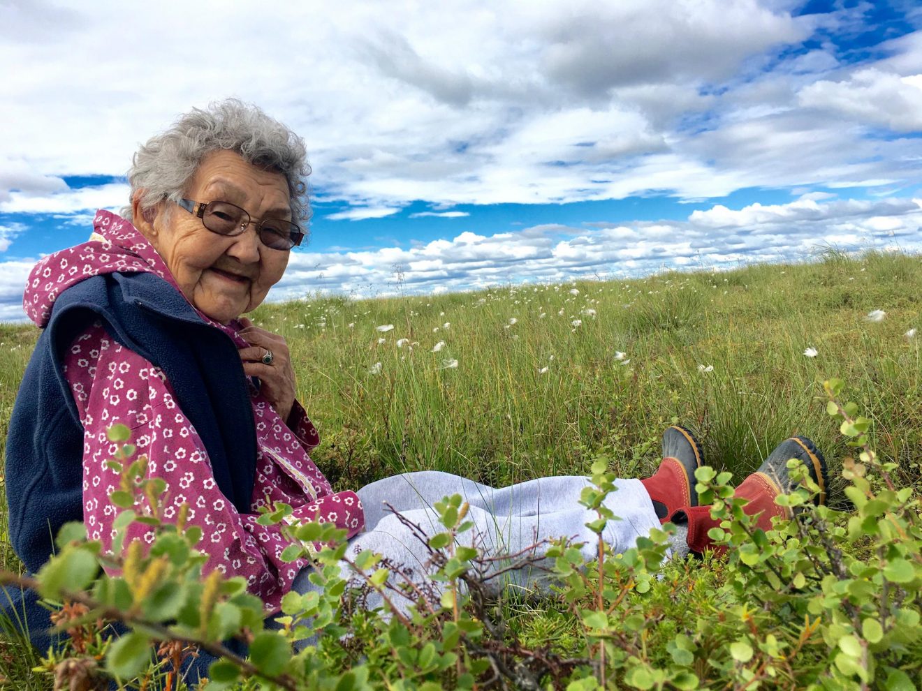 Alaska Native Elder Esther Green sitting on the tundra
