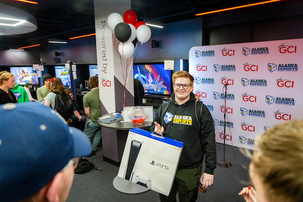 A UAF student wins a brand new PS5 at the 2023 Esports Block Party raffle in the Alaska Esports Center