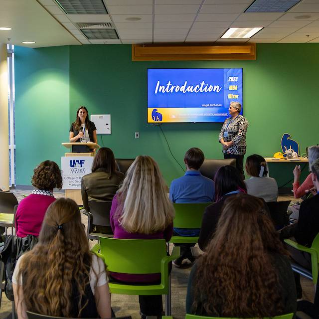 A student presents at the UAF College of Business and Security Management MBA mixer.