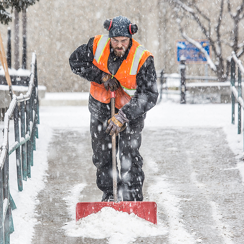 Maintenance crew foreman Raif Kennedy works to clear a path in front of the Rasmuson Library during a brief but heavy snowfall Nov. 5 on the Fairbanks campus.
