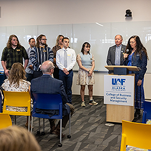 Director of Student Success Shelbie Umphenour explains the Statement of Sigma during the UAF College of Business and Security Management Beta Gamma Sigma Sword and Shield Induction Ceremony in the BP Design Theatre on the UAF campus Thursday, May 4, 2023. UAF photo by Eric Engman.