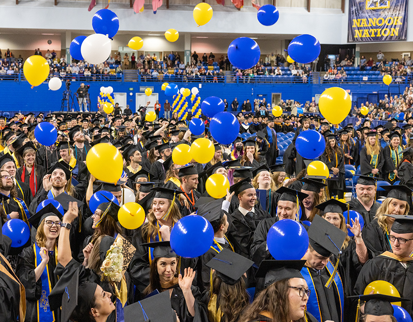 Graduates celebrate during the balloon drop at the University of Alaska Fairbanks 2023 Commencement Ceremony at the Carlson Center Saturday, May 6, 2023. UAF Photo by Eric Engman.