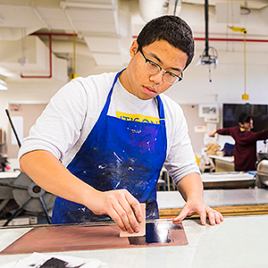 Devante Owens makes a print at the printmaking studio at the Fairbanks campus. Owens is a bachelor of fine arts student at the College of Liberal Arts. UAF Photo by JR Ancheta