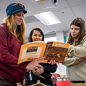 SOE students (from left to right) May Huntley, Thomasina Tall and Megan Koster create a lesson plan in their classroom space on the 7th floor of the Gruening Building. UAF photo by Leif Van Cise.