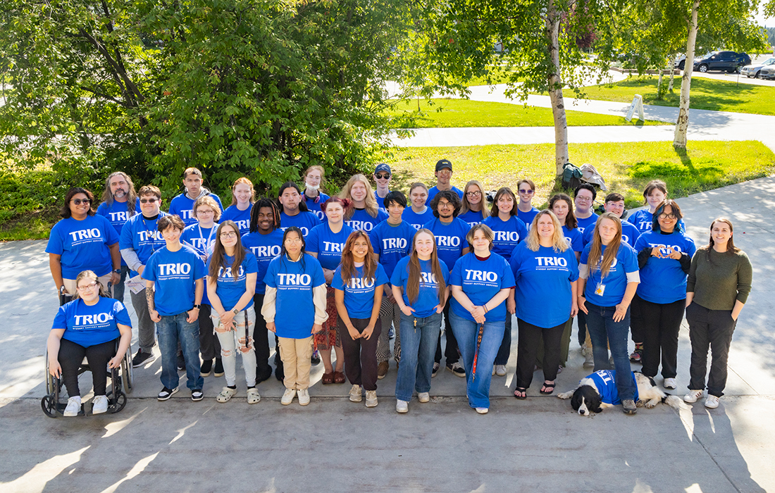 TRIO emerging scholars take a group photo in front of the Rasmuson Library in Cornerstone Plaza, Aug. 5, 2024. UAF Photo by Leif Van Cise.