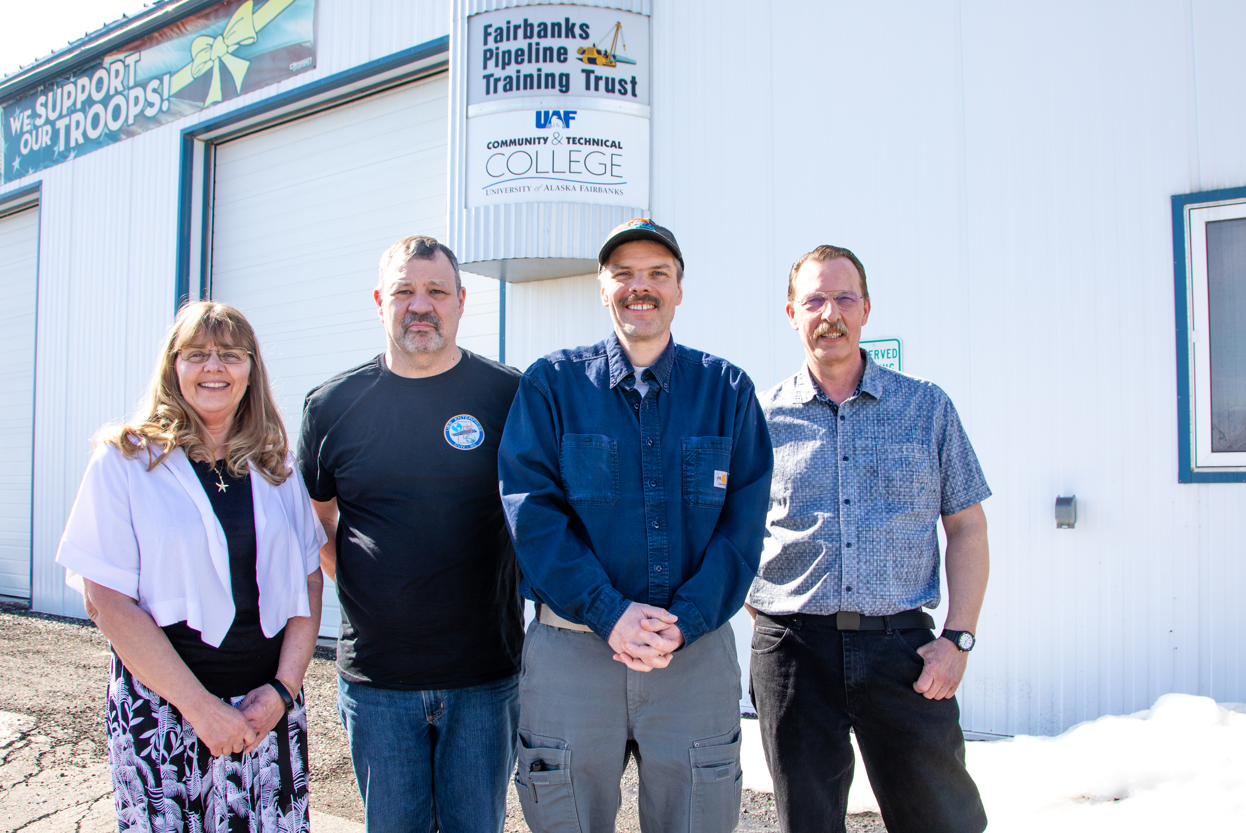 From left, program support staff member Cheri Renson joins Fonger, Varga and associate professor and program coordinator Brian Ellingson outside the process technology facility at the Fairbanks Pipeline Training Center off Van Horn Road in April 2022.