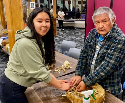 An RHS student and an Elder work together to build a skin drum