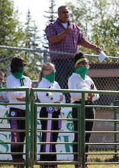 Three 4-H youth wearing gators at public event