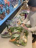 preparing bags of produce for the Snack program