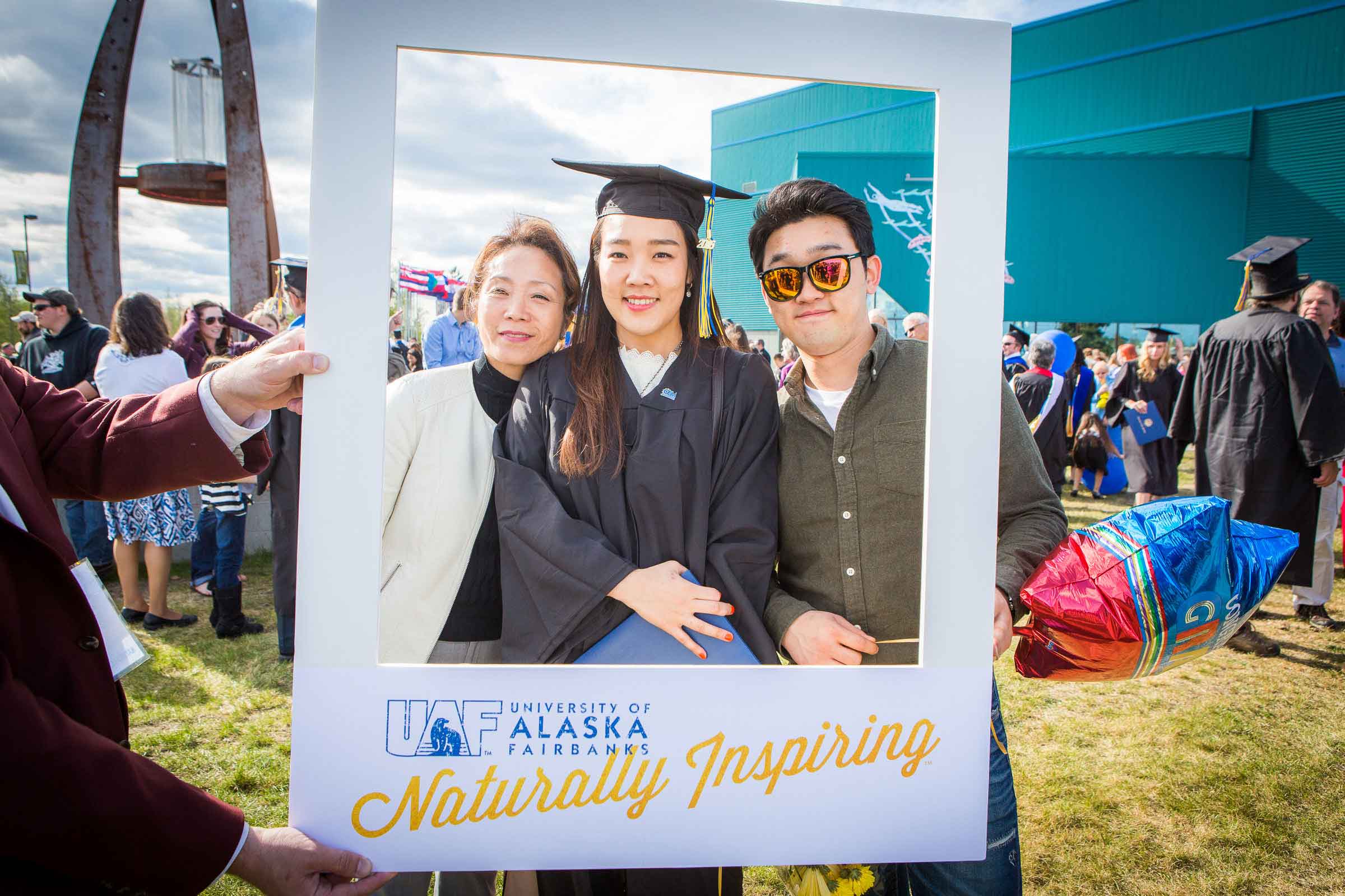 UAF graduate with family at the Carlson Center in Fairbanks.