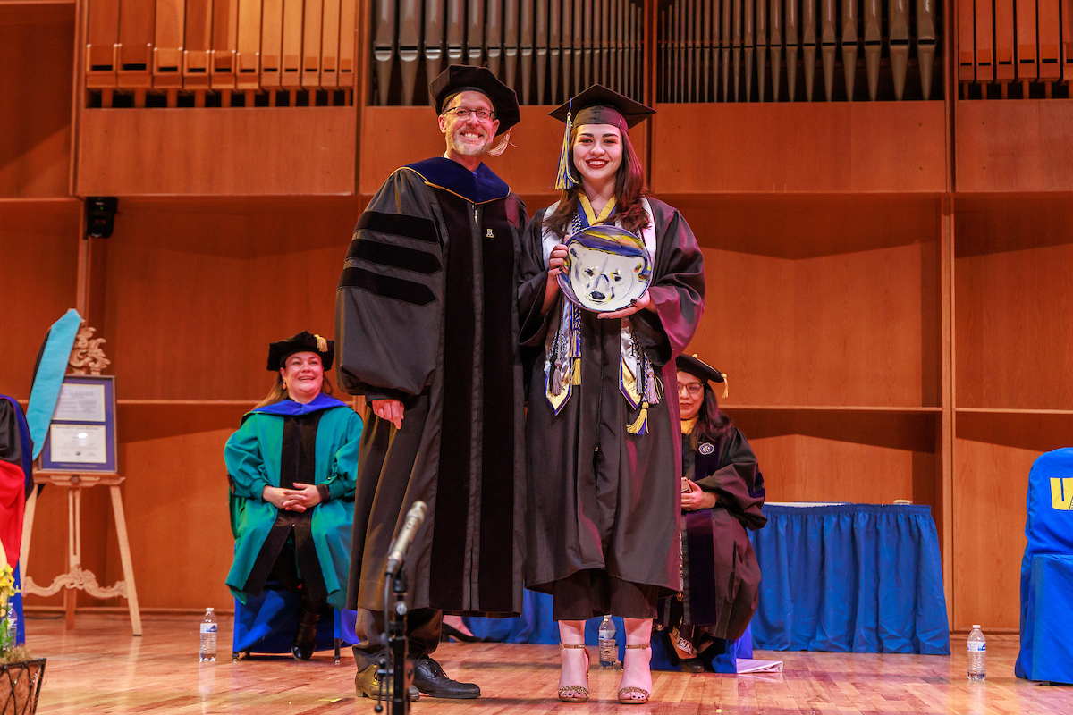 Riley von Borstel stands with UAF Chancellor Dan White after being awarded the Marion Frances Boswell Memorial Award, which recognizes an outstanding bachelor's degree candidate during UAF's 101st commencement ceremonies May 5 in the Davis Concert Hall. Von Borstel received bachelor’s degrees in justice, political science and performing arts, with minors in social work, psychology and creative writing. UAF Photo by Todd Paris