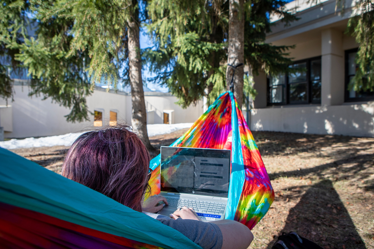 Victoria Nelson studies in her hammock on lower campus. (UAF photo by Leif Van Cise)