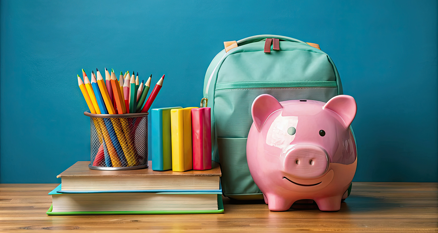 School supplies and piggy bank on a table