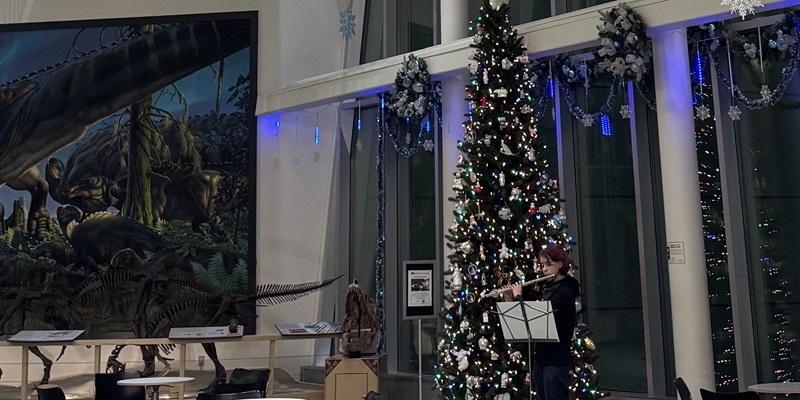 Flutist plays in the museum's lobby.