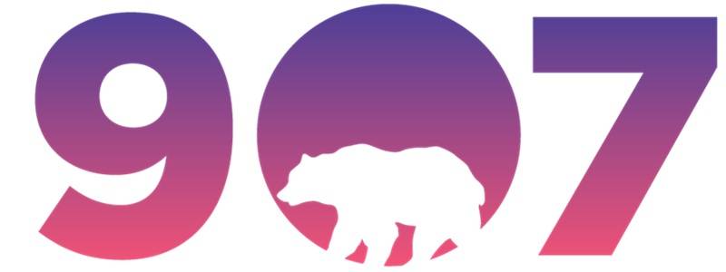 Purple and orange logo with a silhouette of a bear and the words 