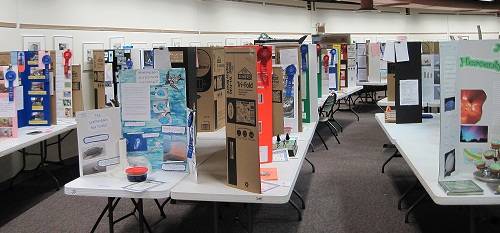 Science fair project posters on a table.