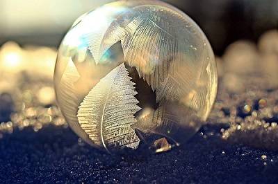 Frozen soap bubble on snow.