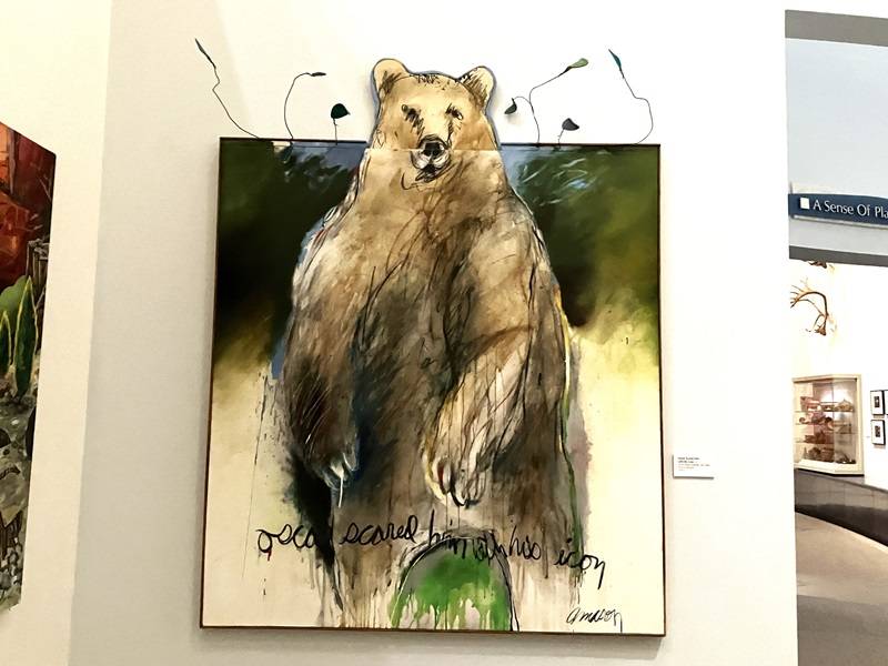Painting of a large brown bear standing on its hind legs.