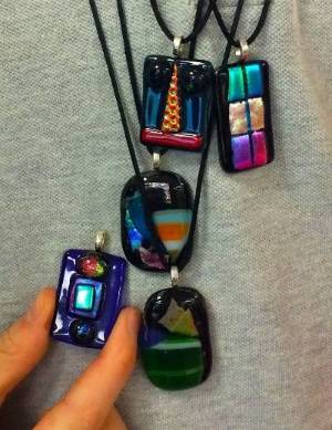 Five glass pendants in various colors.