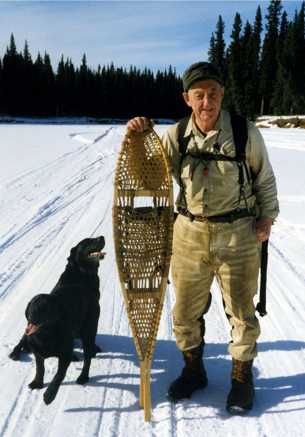 Image of Bill Stroecker snowshoeing with dog