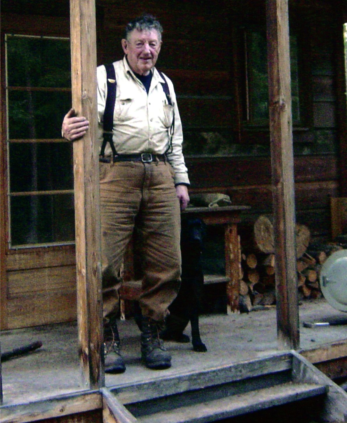 Image of Bill Stroecker standing in front of cabin