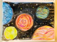 Colorful planets drawn with crayon on a black watercolor background.