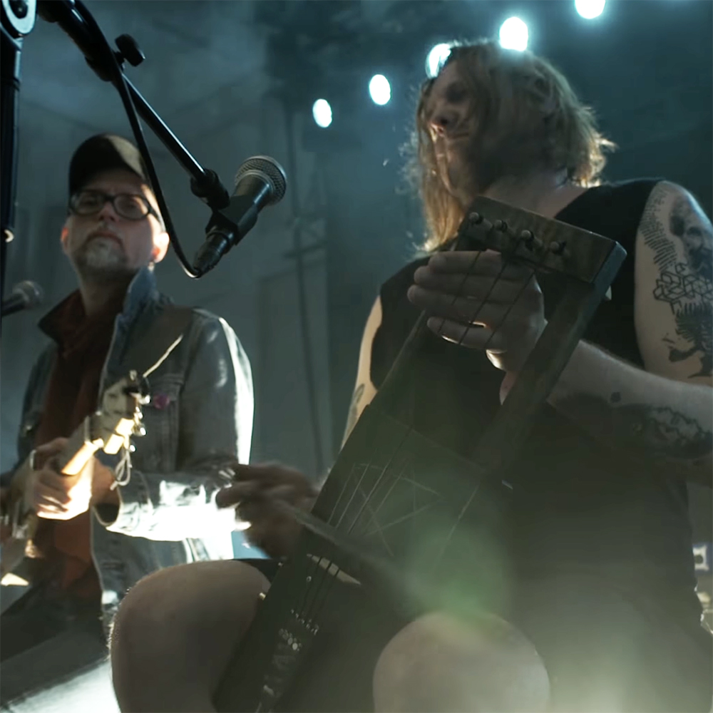 Pekko Käppi (and a bandmate from KHHL) plays the jouhikko onstage | Screenshot from promo video Live at Tuska 2017