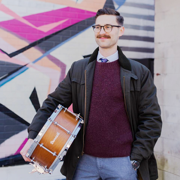 Christopher Hull holding a drum. Photo courtesy of Christopher Hull