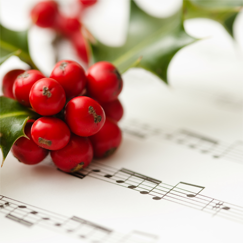 Sheet music with holly. Image courtesy of Canva