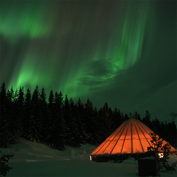 Illuminated Sami tent under the aurora | Canva Photo